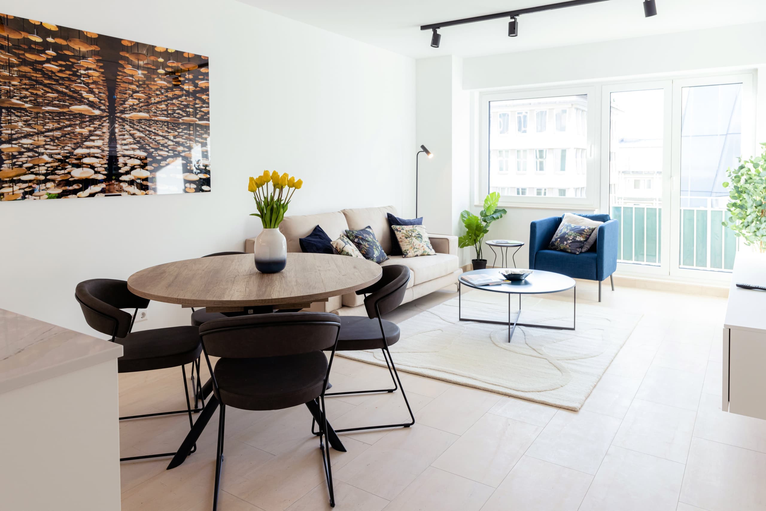 Dining and lounge of Apartment Syre at Hamilius Apartments showing plant and flower in a vase.