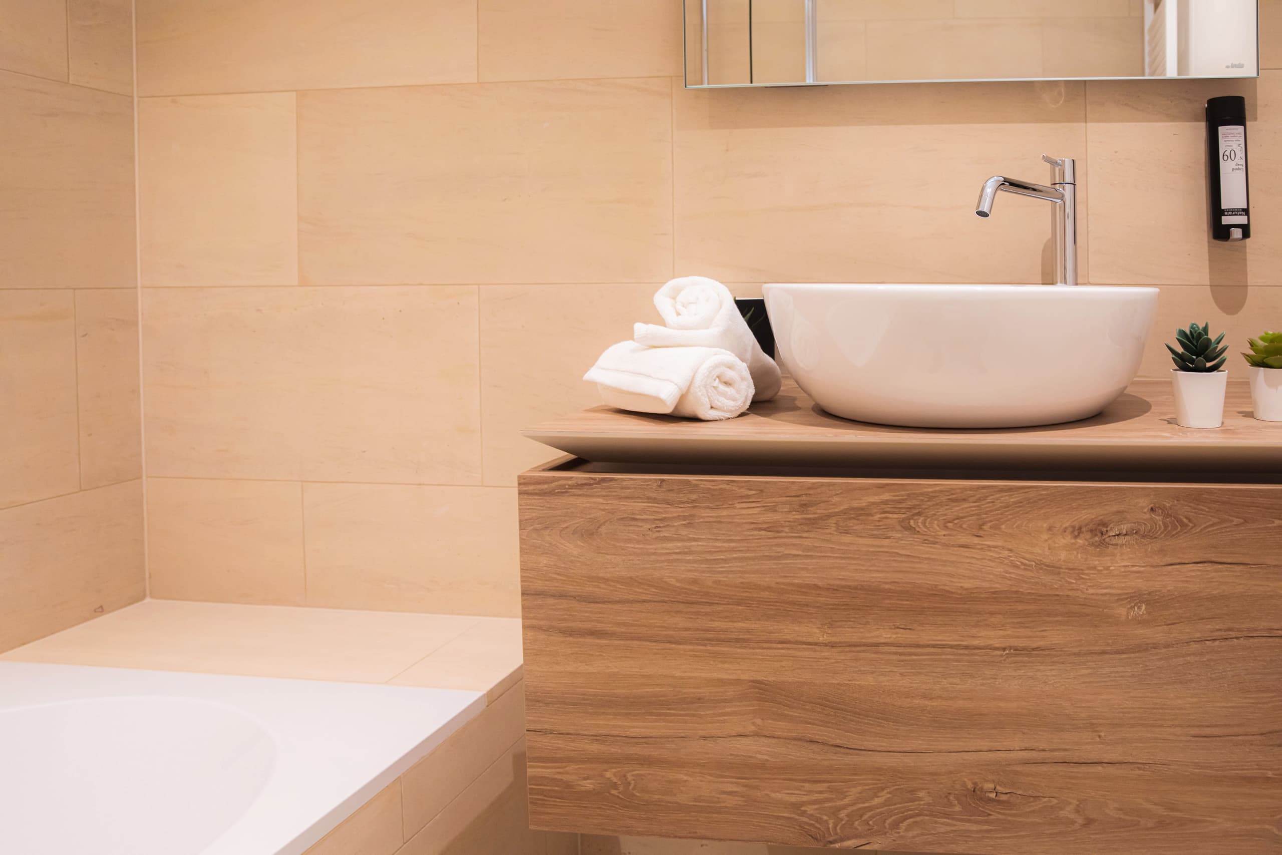 Bathroom with a white hot tub and a white sink. All amenities included.