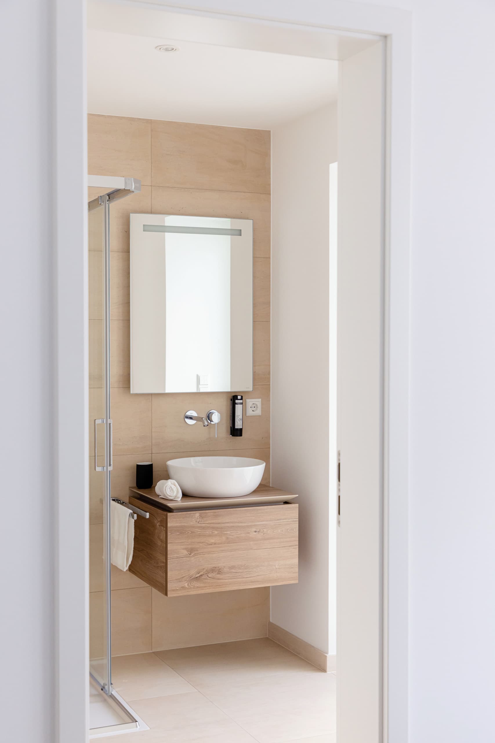 Shower room in Apartment Blees at Hamilius Apartments showing a sink and the door to the private balcony