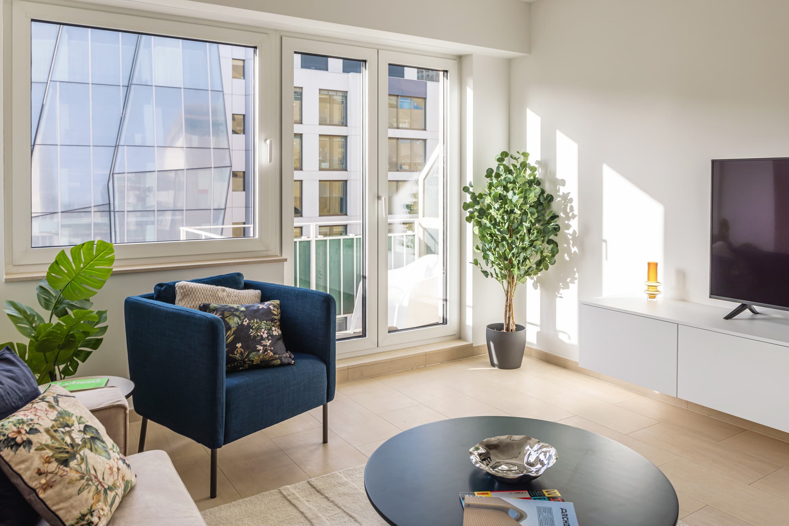 Seating area of Apartment Attert at Hamilius Apartments showing a plant in a plant pot and a view of the balcony